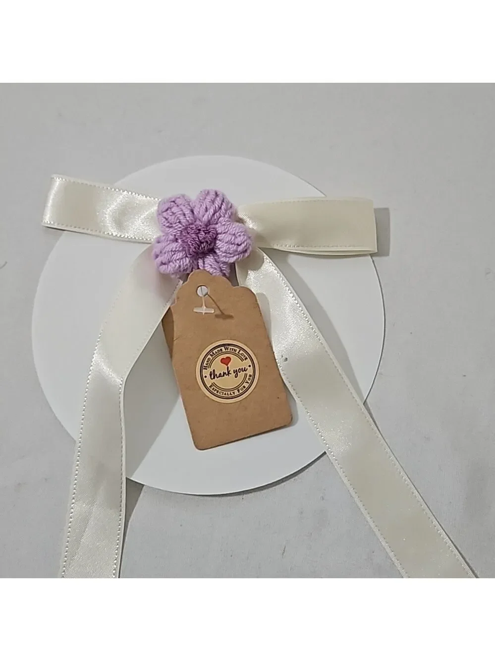 Hand Crafted Ivory Bow with Purple Crochet Flower